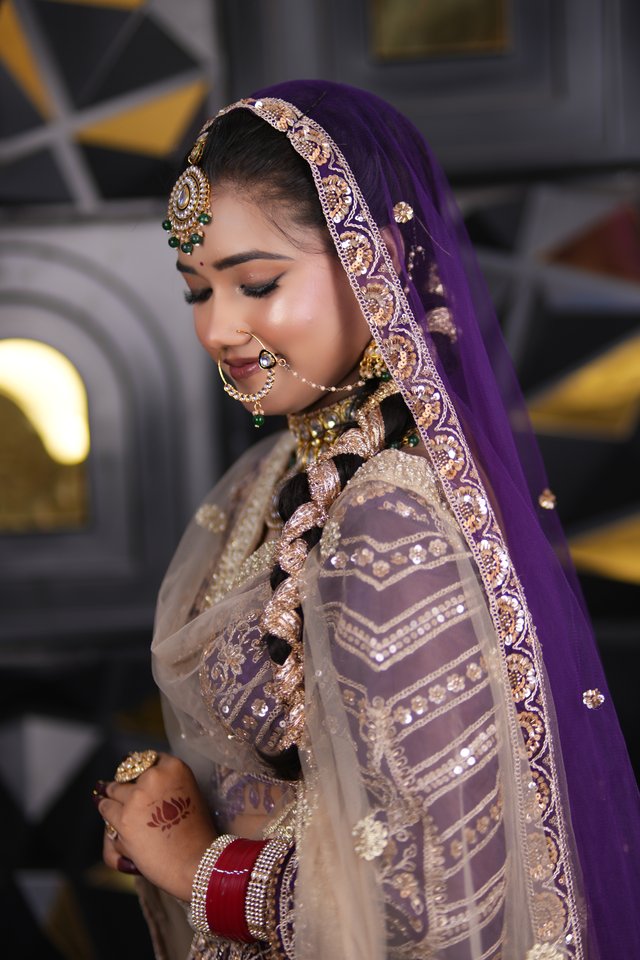 Soft-toned bridal makeup in muted purple and cream, natural and effortless finish